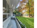 Charming home with a side porch, lush landscaping, and mature trees providing shade and privacy at 1921 Westwood Sw Ave, Atlanta, GA 30310