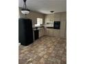 Galley kitchen with black appliances and tile floor at 1473 Brownleaf Dr, Jonesboro, GA 30236