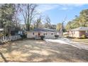 Front yard view of charming ranch home with landscaping at 2077 Rosewood Rd, Decatur, GA 30032