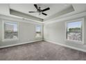 Spacious bedroom with tray ceiling, plush carpet, and large windows for ample natural light at 3541 Koyla Lndg, Chamblee, GA 30341