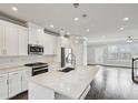 Modern kitchen features white cabinets, a large island, stainless steel appliances, and pendant lighting at 3541 Koyla Lndg, Chamblee, GA 30341