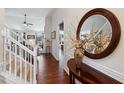 Elegant foyer with hardwood floors, a staircase, and stylish decor, creating a warm welcome at 535 Cape Ivey Dr, Dacula, GA 30019