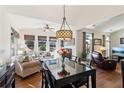 Bright living and dining area filled with natural light, hardwood floors and stylish furniture at 535 Cape Ivey Dr, Dacula, GA 30019