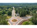 Bird's eye view capturing the property's location at a roundabout, surrounded by mature trees and easily accessible roads at 4205 Jim Owens Nw Rd, Kennesaw, GA 30152