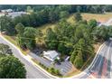 Expansive aerial view of the property, highlighting its generous lot size, surrounded by lush trees and convenient parking area at 4205 Jim Owens Nw Rd, Kennesaw, GA 30152