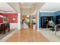 Two-story foyer with hardwood floors, red and blue walls, and views to dining and office areas at 724 Landsdowne Ln, Locust Grove, GA 30248