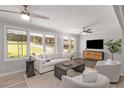 Bright living room with hardwood floors, comfortable seating, and large windows at 1352 Jennie Sw Ln, Lilburn, GA 30047