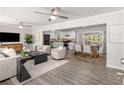 Open concept living space with hardwood floors, modern furniture, and kitchen views at 1352 Jennie Sw Ln, Lilburn, GA 30047