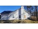 Side view of house with yard and wooden fence at 1432 Cutters Mill Dr, Lithonia, GA 30058