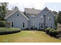 Two-story house with gray stucco siding, landscaping, and a large front yard at 5711 Brynwood Nw Cir, Acworth, GA 30101