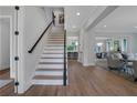 Modern staircase with black metal railing and light hardwood treads at 3227 Ivanhoe Nw Dr, Atlanta, GA 30327