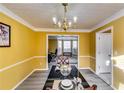 Dining room with chandelier and view into the living area at 3447 Portsmouth Cir, Stonecrest, GA 30038