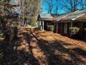 Brick rancher with carport, surrounded by autumn leaves at 5375 Northland Ne Dr, Sandy Springs, GA 30342