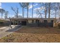 Charming single-story home featuring a covered carport, a long driveway and freshly painted exterior at 3413 Canadian Way, Tucker, GA 30084