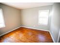 Simple bedroom with hardwood floors and a window at 1351 Harbin Rd, Atlanta, GA 30311