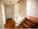 Classic wooden staircase with white railings leading to the second floor at 1351 Harbin Rd, Atlanta, GA 30311