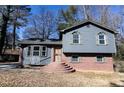 Two-story house with gray siding, brick base, and a small, landscaped yard at 2761 Rockdale, Decatur, GA 30034