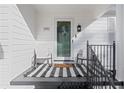 Inviting front porch with rocking chairs and stylish striped rug at 390 Cascade Nw Dr, Marietta, GA 30064