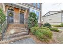 Brick steps leading to double front doors of townhome with railings and landscaping at 4323 Tacoma Trce, Suwanee, GA 30024