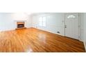 Bright living room featuring hardwood floors and a brick fireplace at 476 Cody Ln, Douglasville, GA 30134