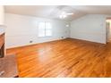 Hardwood floor living room with fireplace and vaulted ceiling at 476 Cody Ln, Douglasville, GA 30134