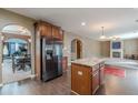 Open-concept kitchen with stainless steel appliances, granite countertops, island, and dark hardwood floors at 1411 Splitrock Sw Pl, Atlanta, GA 30331