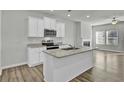 Spacious kitchen featuring white cabinets, granite countertops, and an island at 4336 Mallory Ct, Union City, GA 30291