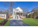 Two-story modern home with gray brick, front porch, and landscaped lawn at 1565 Pineview Sw Ter, Atlanta, GA 30311