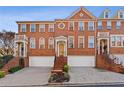 Three-story brick townhome with attached garage, steps, and landscaping at 2428 Bridlewood Se Dr # 24, Atlanta, GA 30339