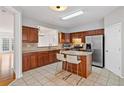 Well-lit kitchen features stainless steel appliances, a center island with bar stools, and ample cabinet space at 2428 Bridlewood Se Dr # 24, Atlanta, GA 30339