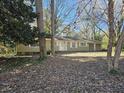 House exterior showcasing a light green painted home with a large yard at 425 Hilderbrand Dr, Sandy Springs, GA 30328