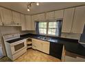 White kitchen cabinets, black countertops, and white appliances at 425 Hilderbrand Dr, Sandy Springs, GA 30328