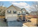 Two-story house with a brick and siding exterior, and rocking chairs on porch at 502 Starling View Cir, Grayson, GA 30017