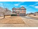 Two-story brick home with a red door and landscaping at 845 Nevis Way, Mcdonough, GA 30253