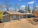 Gray house with attached garage and large yard at 103 Cardinal Se Rd, White, GA 30184