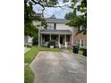 Tan townhome with a covered porch and small front yard at 308 Flagstone Way # 308, Austell, GA 30168