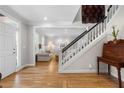 Bright foyer with hardwood floors, staircase, and view into the living room at 685 Greystone Ne Park, Atlanta, GA 30324