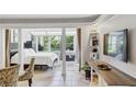 Open bedroom with a sunroom and a view into the living space at 141 Maison Nw Pl, Atlanta, GA 30327
