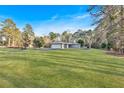 Expansive front yard view of a home surrounded by mature trees at 4847 Lakewood Dr, Acworth, GA 30101