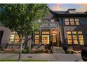 Evening view of townhome exterior, illuminated windows, and landscaping at 6816 Prelude Dr, Sandy Springs, GA 30328