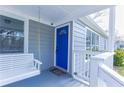 View of the front porch featuring a white porch swing, blue front door, and white railing at 1268 Kenilworth Sw Dr, Atlanta, GA 30310