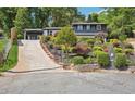 Charming two-story house with lush landscaping, a long driveway, and a quaint mailbox at 2139 Cedarbrook Se Ct, Atlanta, GA 30316