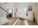 Bright and spacious entryway with hardwood floors and a view into the living room at 4414 Parmalee Path, Conley, GA 30288