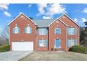 Two-story brick home with a two-car garage and nicely landscaped yard at 4414 Parmalee Path, Conley, GA 30288