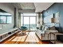 Modern living room with hardwood floors, large windows, and city views at 250 Pharr Rd # 712, Atlanta, GA 30305