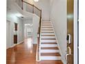 Bright foyer showcasing hardwood floors, staircase with decorative railing and natural light at 1847 Caswell Pkwy # 155, Marietta, GA 30060