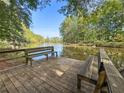 Wooden dock with benches overlooking a serene lake at 234 Hampton Shores Dr, Hampton, GA 30228