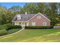 Brick house with walkway and lush green lawn at 234 Hampton Shores Dr, Hampton, GA 30228