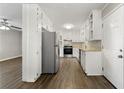 Modern kitchen with white cabinets, granite countertops, and stainless steel appliances at 5533 N Wind Sw Dr, Lilburn, GA 30047