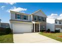 Charming two-story home with brick accents, light blue siding, lush lawn, and two car garage at 816 Royal Red Ct, Mcdonough, GA 30253